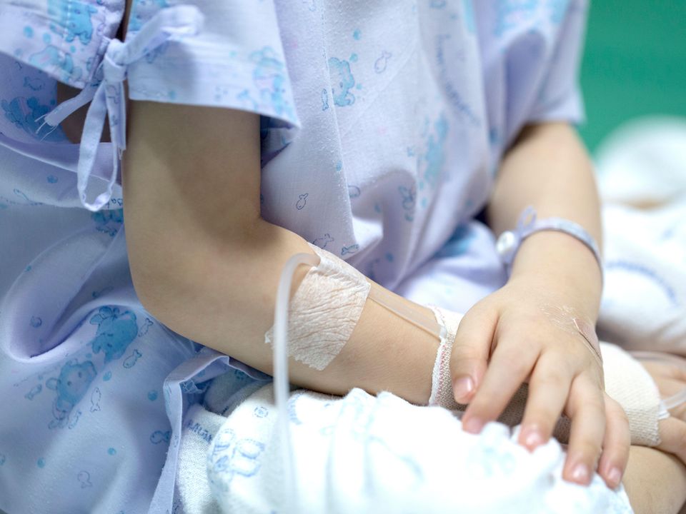 2JK32K4 Sick child on a receiving a saline solution in hospital