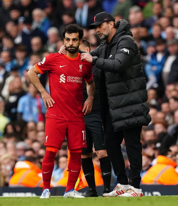 Liverpool manager Jurgen Klopp speaks to Mohamed Salah on the touchline (Martin Rickett/PA).