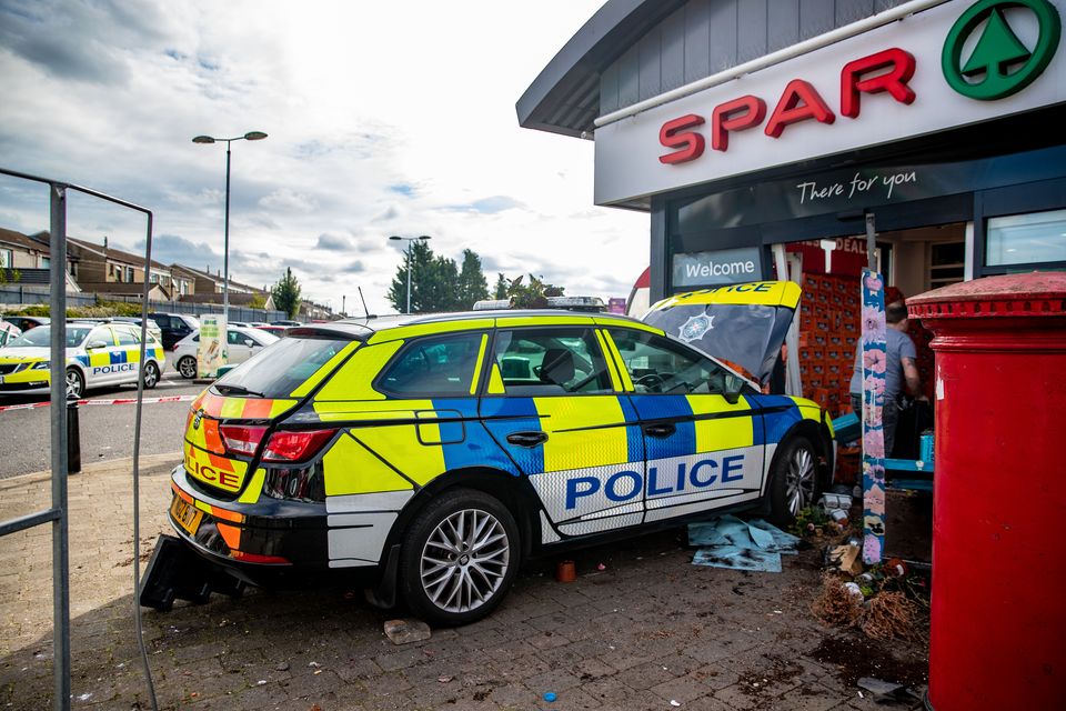 A PSNI car crashed into the shop in Lisburn. Credit: Kevin Scott