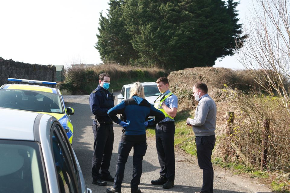 James Mahon (in grey jumper), who is the son of Maureen, in discussion with gardaí and dog warden during an inspection