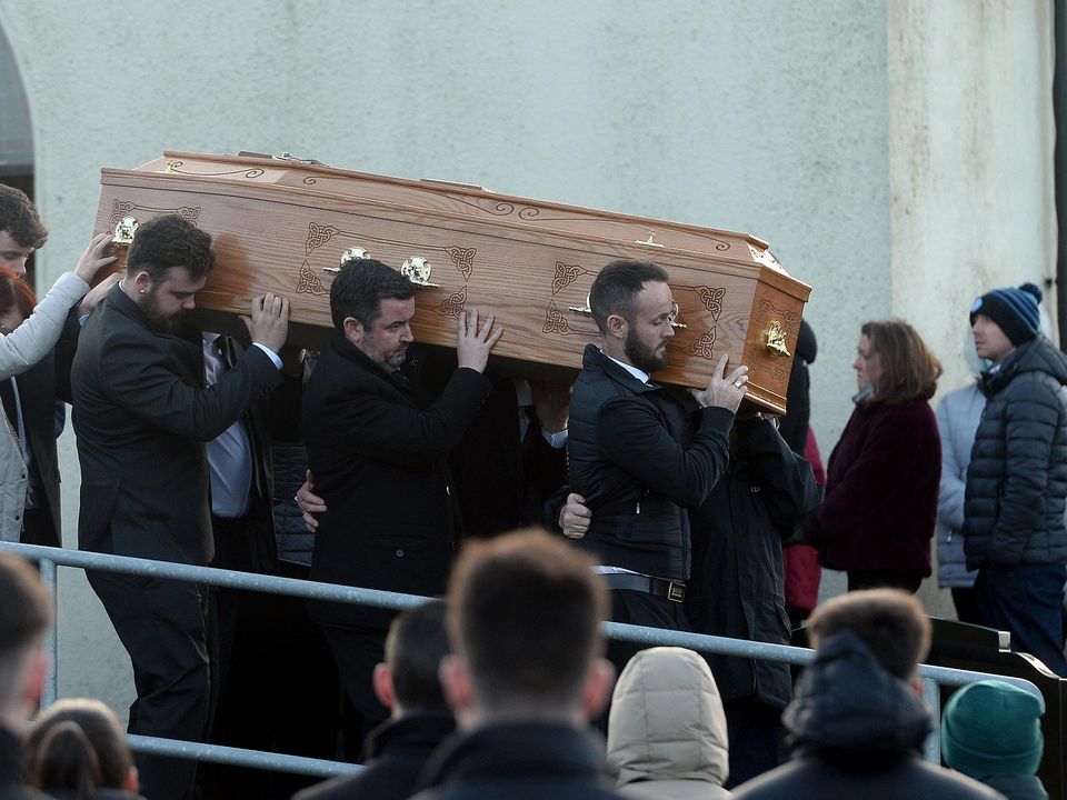 Family members hold the coffin of Nathan Corrigan, 20, as it is carried from St Matthew’s Church (Oliver McVeigh/PA)