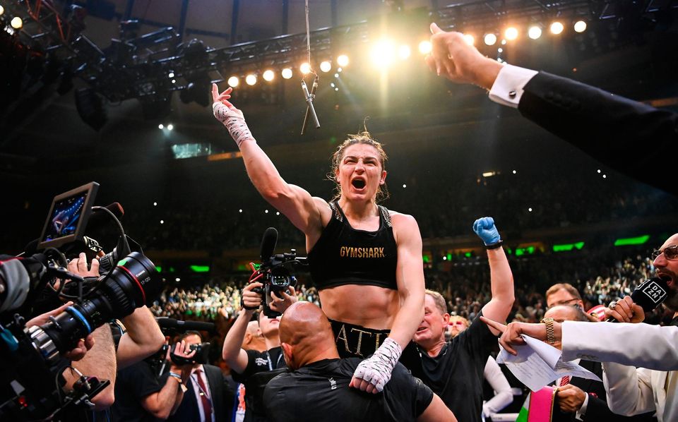 30 April 2022; Katie Taylor and coach Ross Enamait, left, celebrate victory after her undisputed world lightweight championship fight with Amanda Serrano at Madison Square Garden in New York, USA. Photo by Stephen McCarthy/Sportsfile
