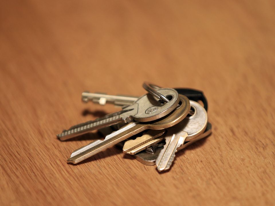 A set of house keys rests on a table.