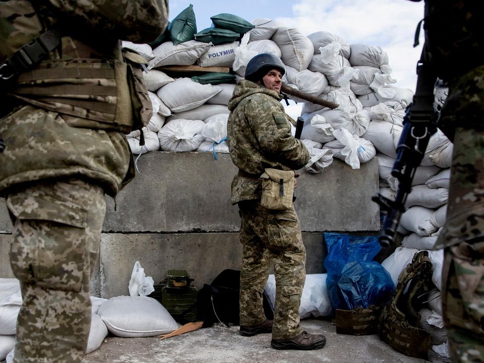 Ukrainian service members at a checkpoint in the city of Zhytomyr, Ukraine. Picture: Reuters