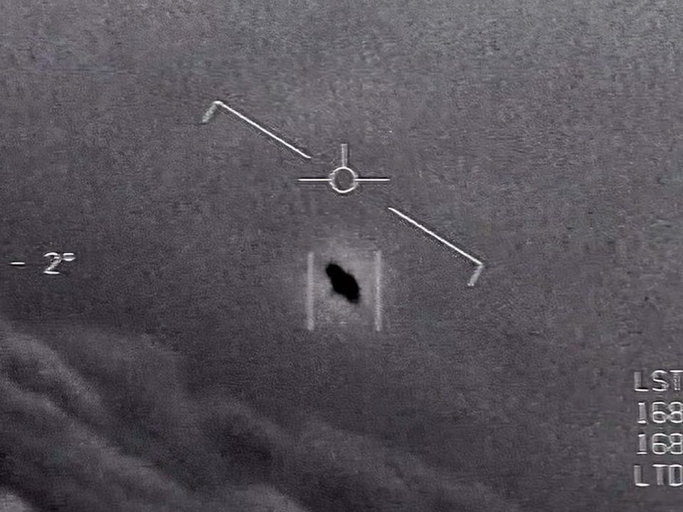 In a still from video footage taken during a separate incident in 2015, an unexplained object is seen at centre as it soars through the clouds. Photo: US Department of Defence