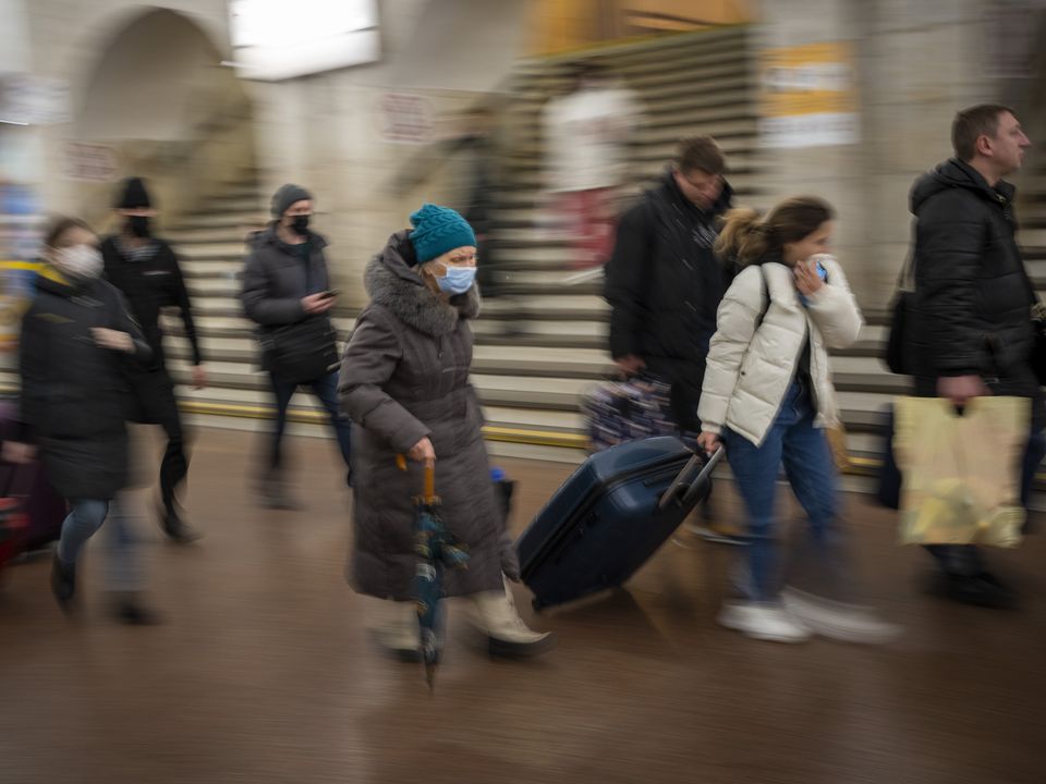 People walk in a subway to get a train as they leave Kyiv, Ukraine (Emilio Morenatti/AP)