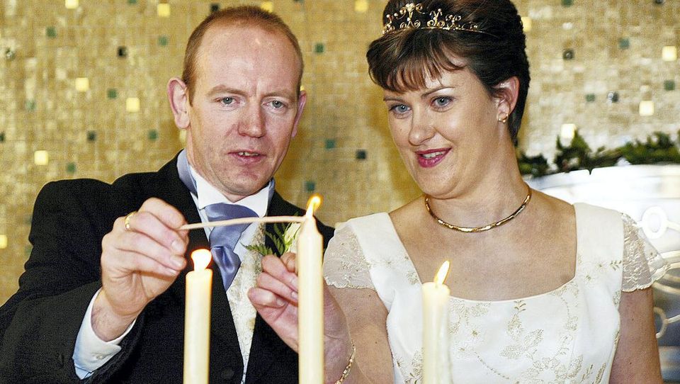 Pearse McAuley and Pauline Tully light a candle after their wedding in Kilnaleck, Co Cavan, in 2003. Photo: John McAviney