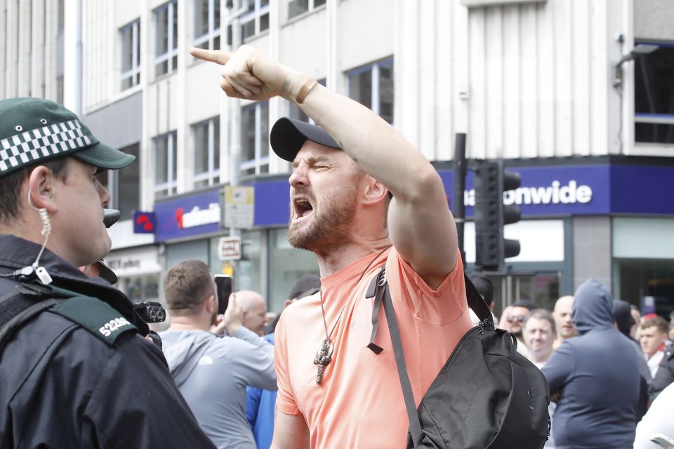 A Dublin-based protester shouts at counter-demonstraters in Belfast yesterday