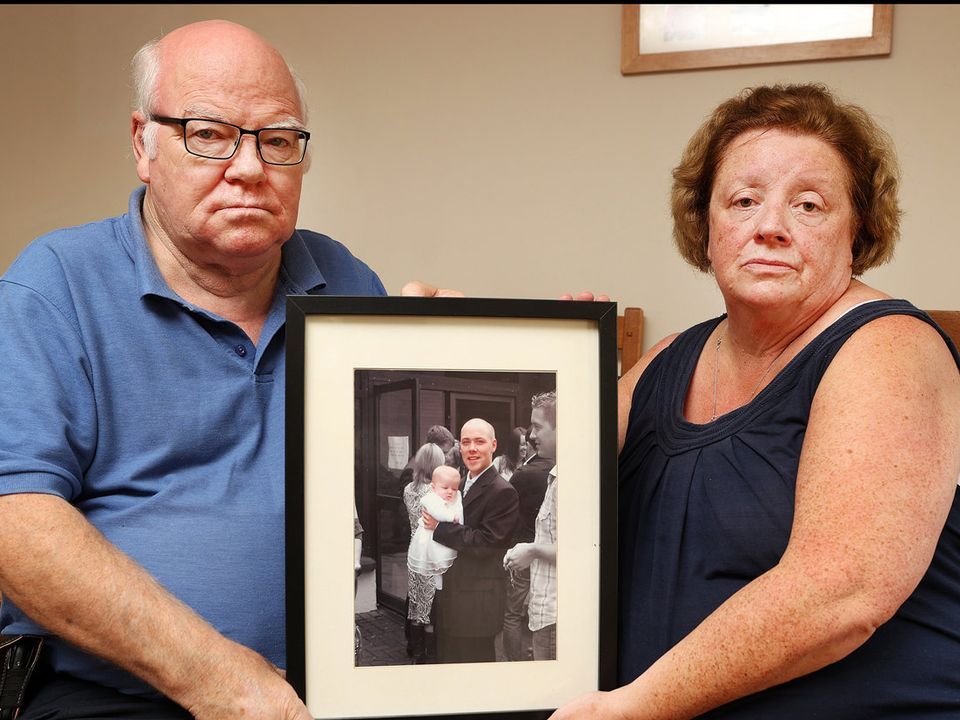 Brian and Grainne Fetherston pictured in 2020 holding a picture of Ken at his daughter Nicole's christening.