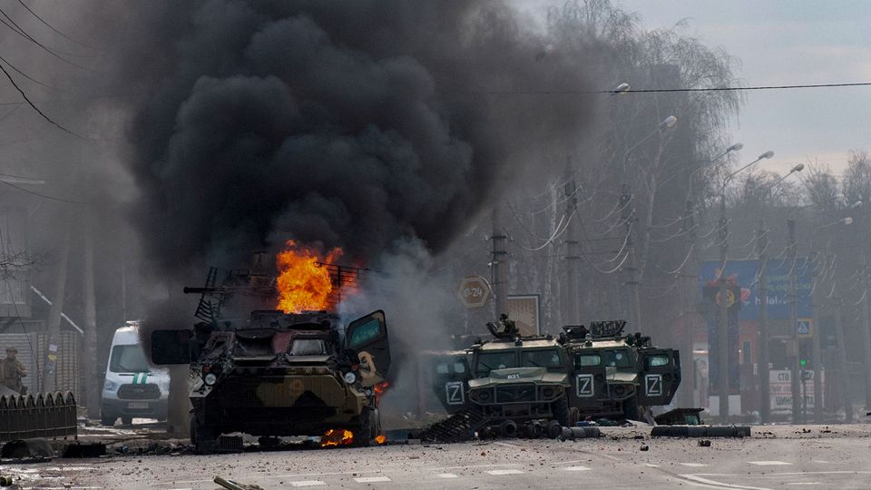 A Russian armoured personnel carrier burns amid damaged and abandoned light utility vehicles after fighting in Kharkiv, Ukraine, Sunday, Feb. 27, 2022. The city authorities said that Ukrainian forces engaged in fighting with Russian troops that entered the country’s second-largest city on Sunday. (AP Photo/Marienko Andrew)