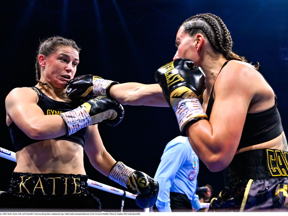 25 November 2023; Katie Taylor, left, and Chantelle Cameron during their undisputed super lightweight championship bout at the 3Arena in Dublin. Photo by Stephen McCarthy/Sportsfile