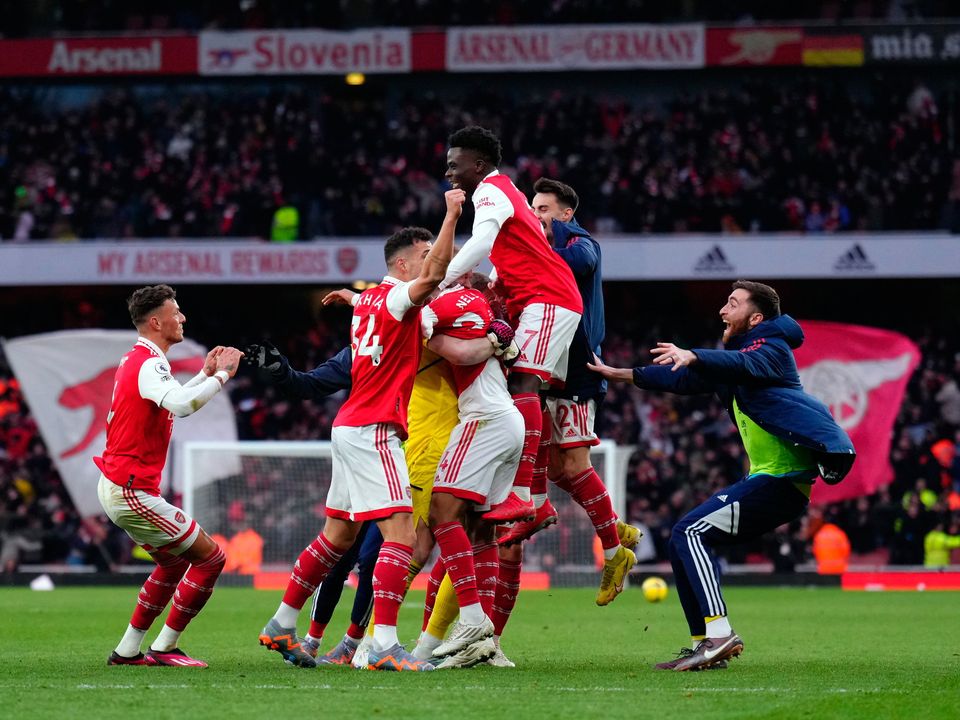 Arsenal's Reiss Nelson is mobbed by team mates as he celebrates scoring his sides third goal: John Walton/PA Wire.