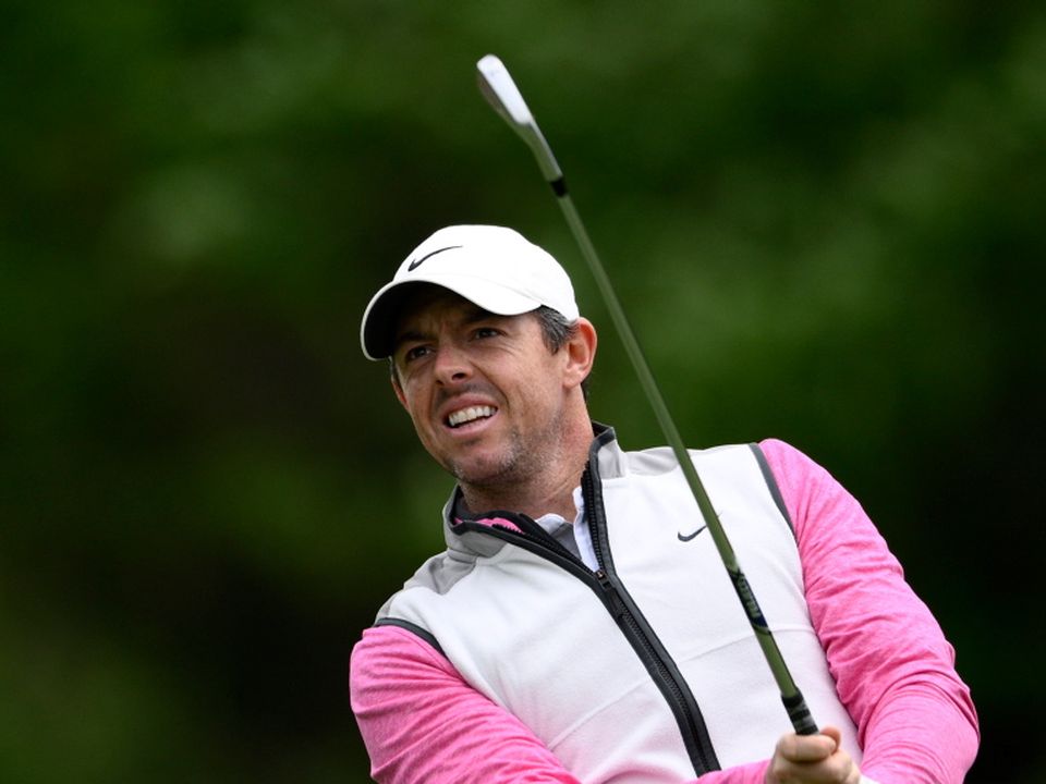 Rory McIlroy reacts to his tee shot on the third hole