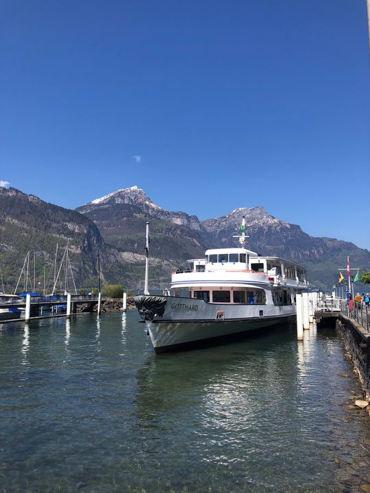 The Gotthard boat sits on the lake with the mountains in the background