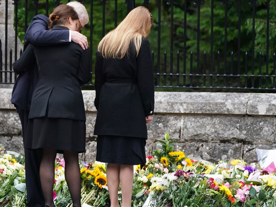 The Duke of York, Princess Eugenie and Princess Beatrice (right) view the messages and floral tributes left by members of the public Balmoral in Scotland following the death of Queen Elizabeth II on Thursday. Picture date: Saturday September 10, 2022.