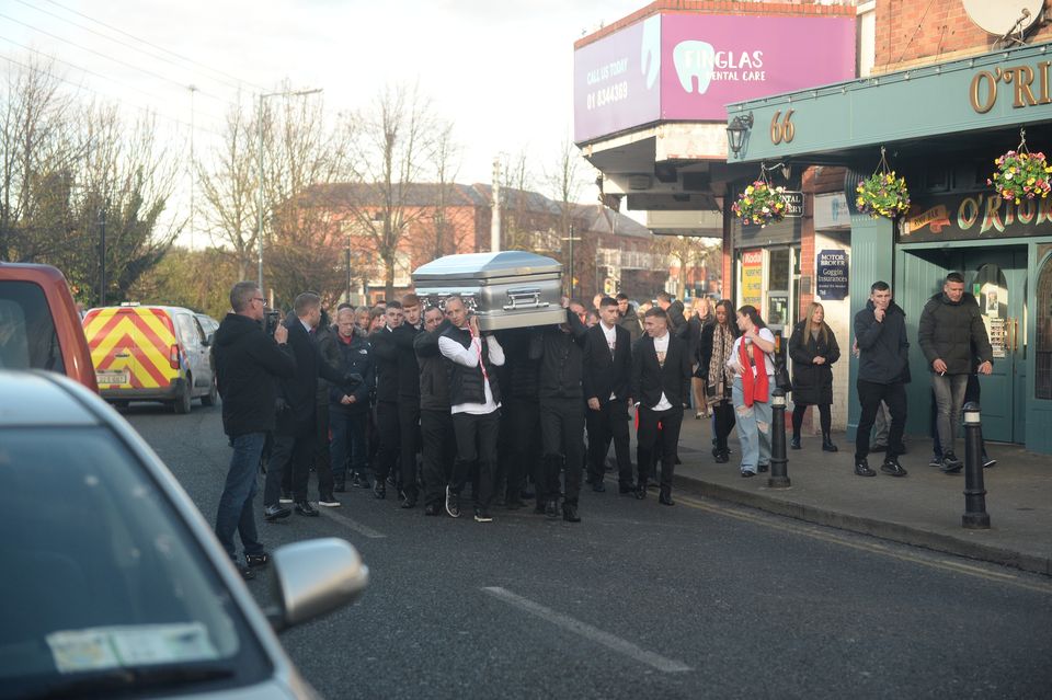 Gun victim Brandon Ledwidge's silver coffin is carried by mourners