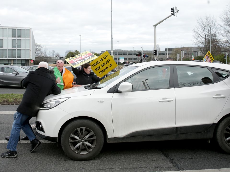 Protesters surround a car outside RTÉ. Picture: Gerry Mooney