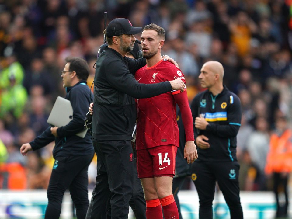 Liverpool manager Jurgen Klopp embraces captain Jordan Henderson after the final whistle (Peter Byrne/PA)