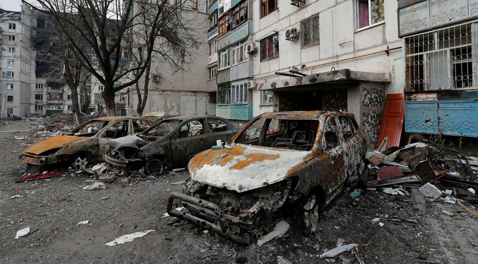 Destroyed cars are seen in front of an apartment building which was damaged during Ukraine-Russia conflict in the besieged southern port city of Mariupol, Ukraine. Picture: Reuters