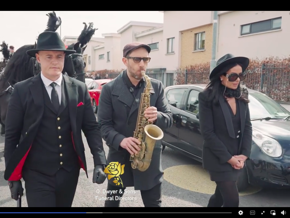 James Whelan's funeral cortege is led by a saxophone player
