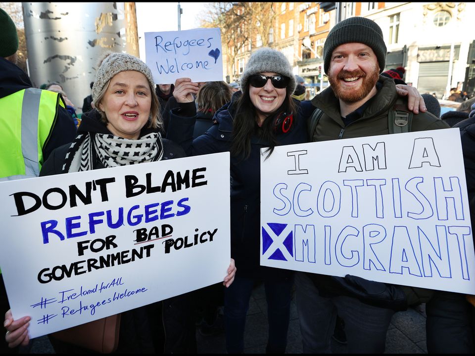 Pro-refugee supporters Aneta Stepien from Poland, Maire Ní Mhardha from Maynooth and Andrew Pringle from Scotland taking part in a rally on O'Connell Street. Photo: Steve Humphreys