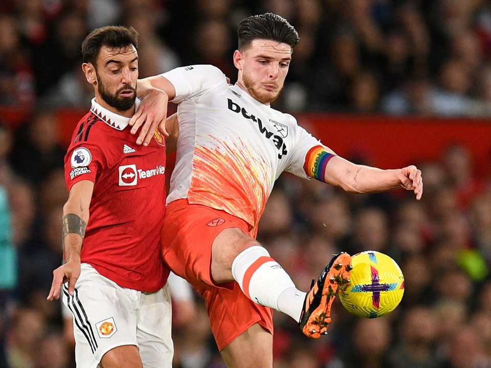 Manchester United's Portuguese midfielder Bruno Fernandes (L) vies with West Ham United's English midfielder Declan Rice (R) during the English Premier League football match between Manchester United and West Ham United at Old Trafford in Manchester, north-west England, on October 30, 2022. - RESTRICTED TO EDITORIAL USE. No use with unauthorized audio, video, data, fixture lists, club/league logos or 'live' services. Online in-match use limited to 120 images. An additional 40 images may be used in extra time. No video emulation. Social media in-match use limited to 120 images. An additional 40 images may be used in extra time. No use in betting publications, games or single club/league/player publications. (Photo by Oli SCARFF / AFP) / RESTRICTED TO EDITORIAL USE. No use with unauthorized audio, video, data, fixture lists, club/league logos or 'live' services. Online in-match use limited to 120 images. An additional 40 images may be used in extra time. No video emulation. Social media in-match use limited to 120 images. An additional 40 images may be used in extra time. No use in betting publications, games or single club/league/player publications. / RESTRICTED TO EDITORIAL USE. No use with unauthorized audio, video, data, fixture lists, club/league logos or 'live' services. Online in-match use limited to 120 images. An additional 40 images may be used in extra time. No video emulation. Social media in-match use limited to 120 images. An additional 40 images may be used in extra time. No use in betting publications, games or single club/league/player publications. (Photo by OLI SCARFF/AFP via Getty Images)