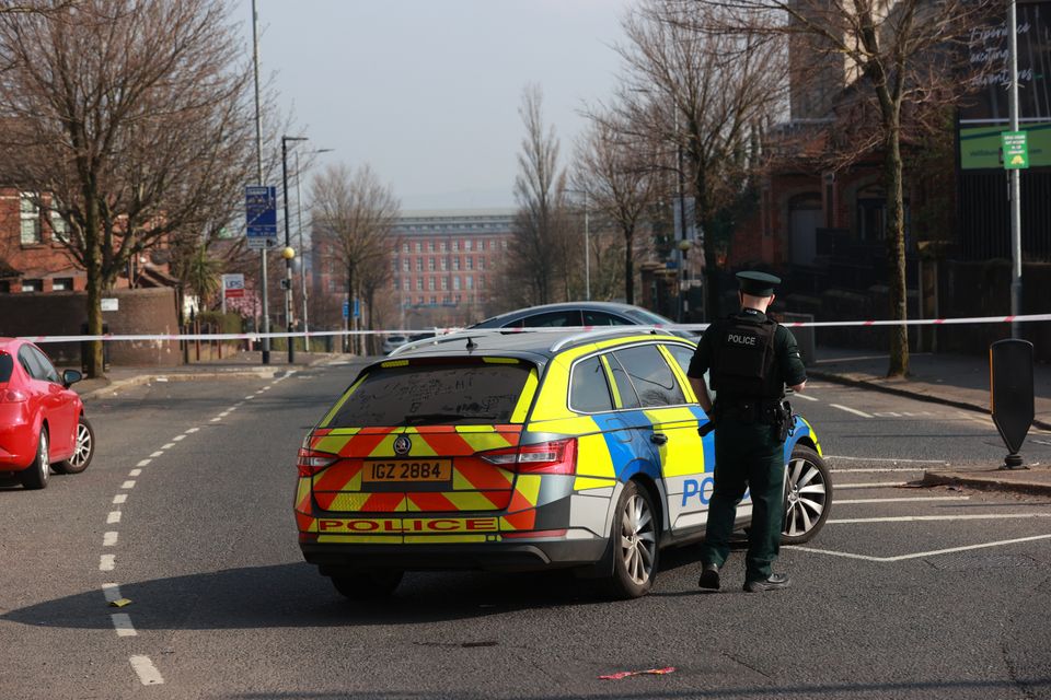PSNI officers patrol a cordon at the Holy Cross church which is believed to centre around a hijacked van, close to The Houben Centre, Belfast (Liam McBurney/PA)