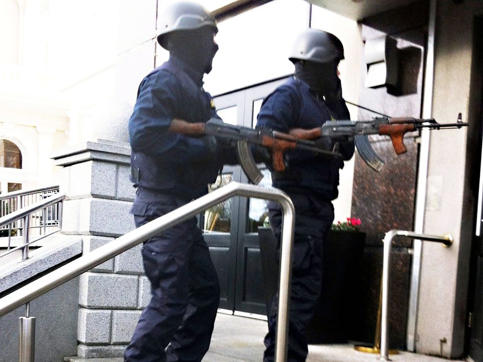 Armed men entering the Regency Hotel