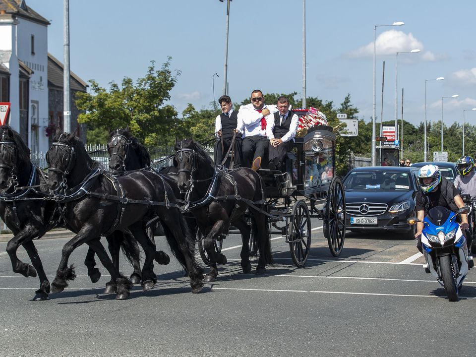A horse-drawn hearse carrying the coffin of Graham Taylor, who was killed in the pursuit on the M7.