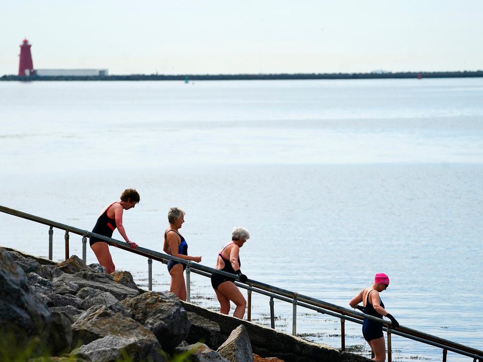 Swimmers at the Bull Wall in Dublin. Met Éireann is forecasting that temperatures will slide back for the weekend. Photo: Brian Lawless