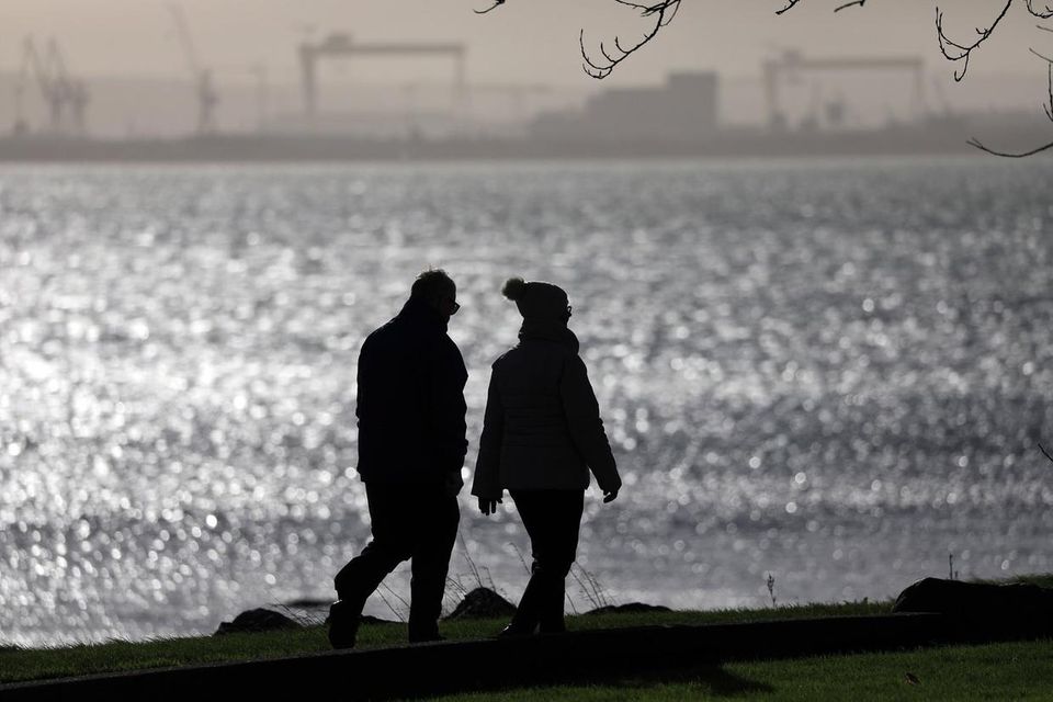 A couple brave the elements during a walk along the sea front at Jordanstown on Saturday. Picture: Peter Morrison