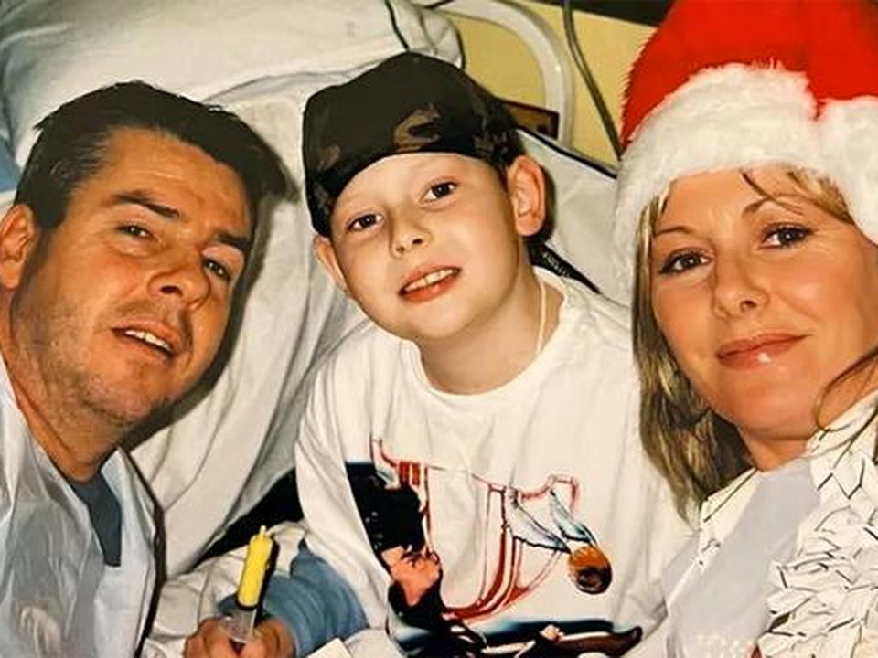 Craig in hospital with his mum and dad during his cancer treatment