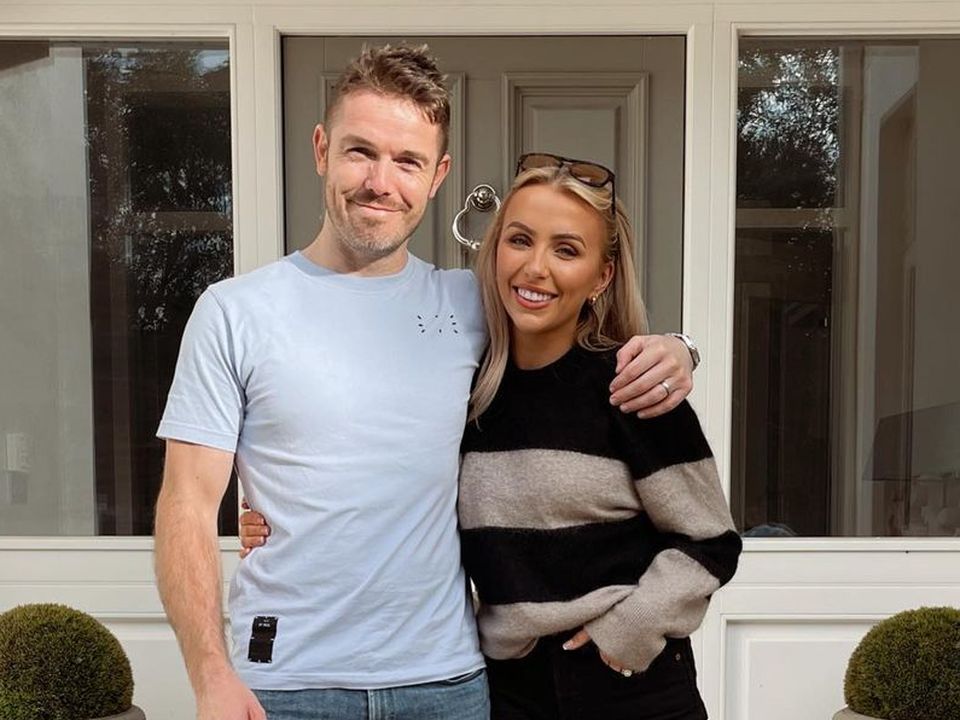 Rosie Connolly and her husband Paul outside their new house