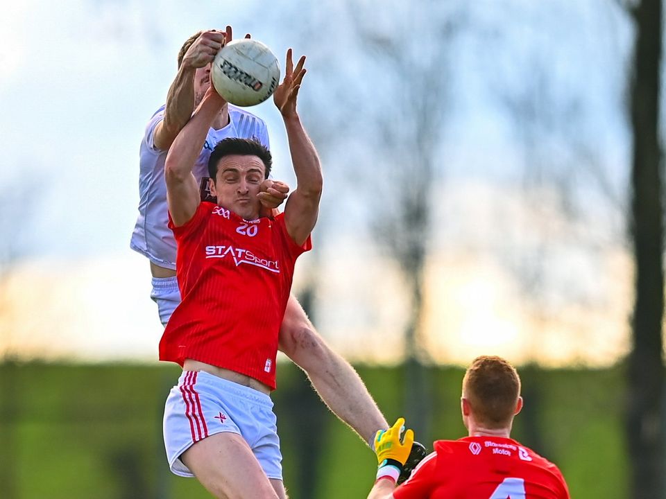 Tommy Durnin of Louth and Kevin Feely of Kildare contest a high ball. Photo: Ben McShane/Sportsfile