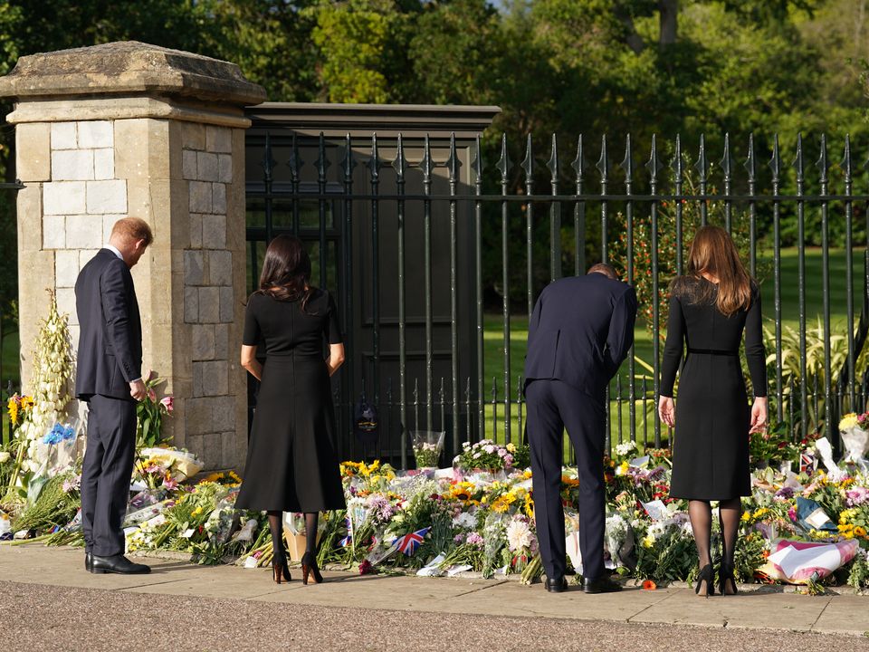 The Duke and Duchess of Sussex and the Prince and Princess of Wales, view flowers left by members of the public at Windsor Castle in Berkshire following the death of Queen Elizabeth II on Thursday. Picture date: Saturday September 10, 2022.