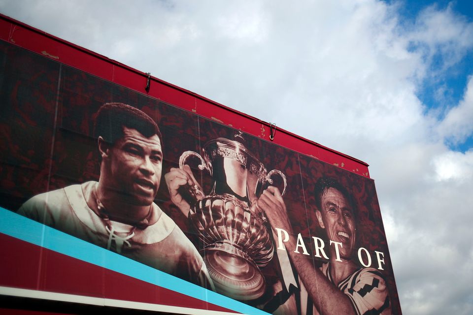 Former Aston Villa players Johnny Dixon (right) with the FA Cup trophy and Paul McGrath on a hoarding at Villa Park prior to the Premier League match against Bournemouth last weekend. Photo: Marc Atkins/Getty Images