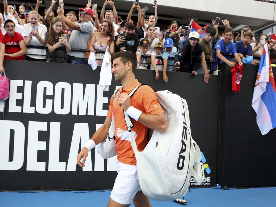 Serbia's Novak Djokovic walks on to center court for his round of 32 match against France's Constant Lestienne at the Adelaide International Tennis tournament in Adelaide, Australia, Tuesday, Jan. 3, 2023. (AP Photo/Kelly Barnes)