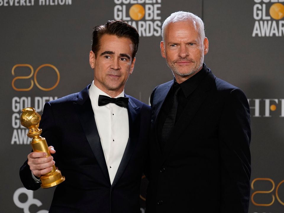 Colin Farrell, winner of the award for best performance by an actor in a motion picture, musical or comedy for "The Banshees of Inisherin," left, and Martin McDonagh
