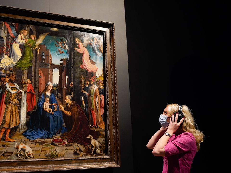 A person looks up at a copy of Jan Gossaert’s Adoration Of The Kings (Andrew Matthews/PA)