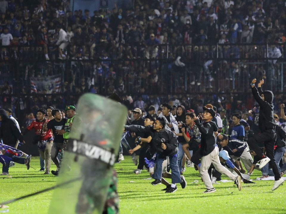 Fans entered the field of play last night in Indonesia. Photo: PA Media.
