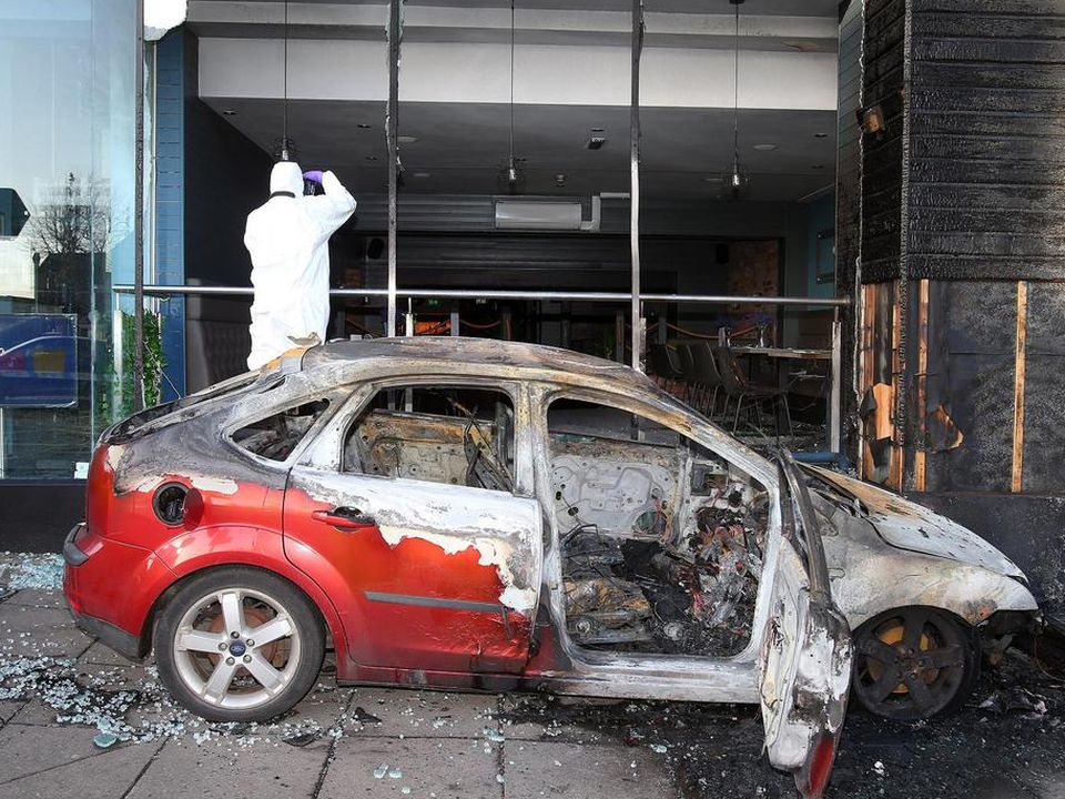 A Ford Focus was driven into the front of the restaurant and set alight in south Belfast
