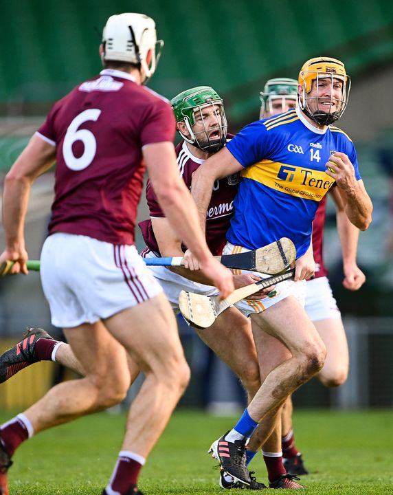 Séamus Callanan of Tipperary is tackled by Galway's Adrian Tuohey