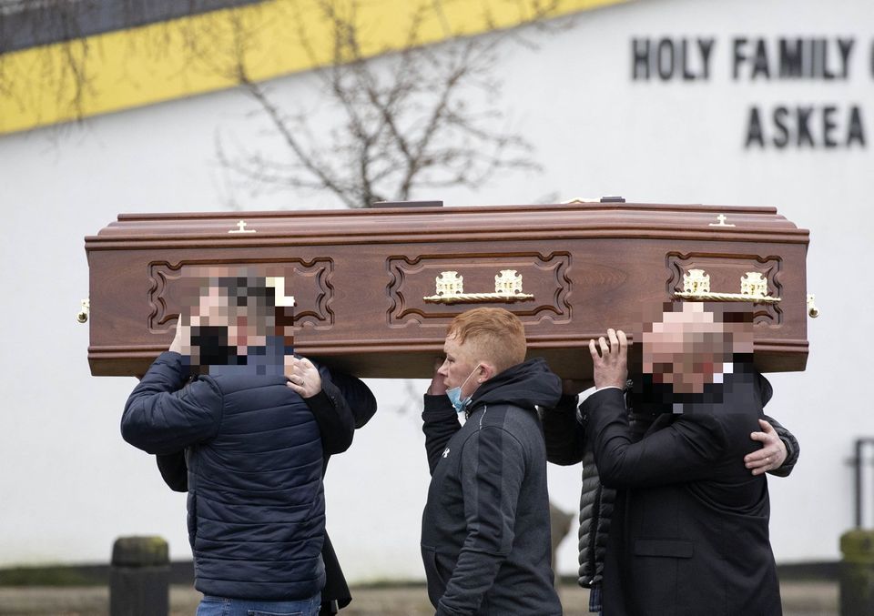 The remains are carried into church by family members and Declan Haughney, centre