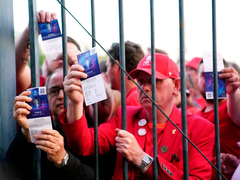 Liverpool fans stuck outside the ground show their match tickets during last year's Champions League final at the Stade de France. Photo by: Adam Davy/PA Wire