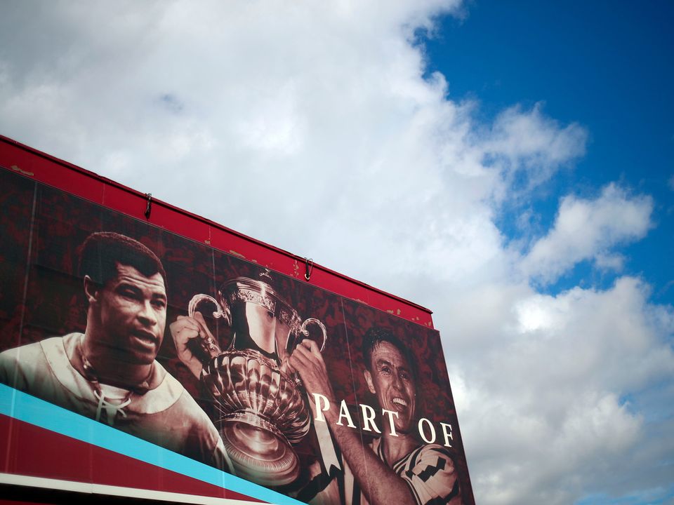 Former Aston Villa players Johnny Dixon (right) with the FA Cup trophy and Paul McGrath on a hoarding at Villa Park prior to the Premier League match against Bournemouth last weekend. Photo: Marc Atkins/Getty Images