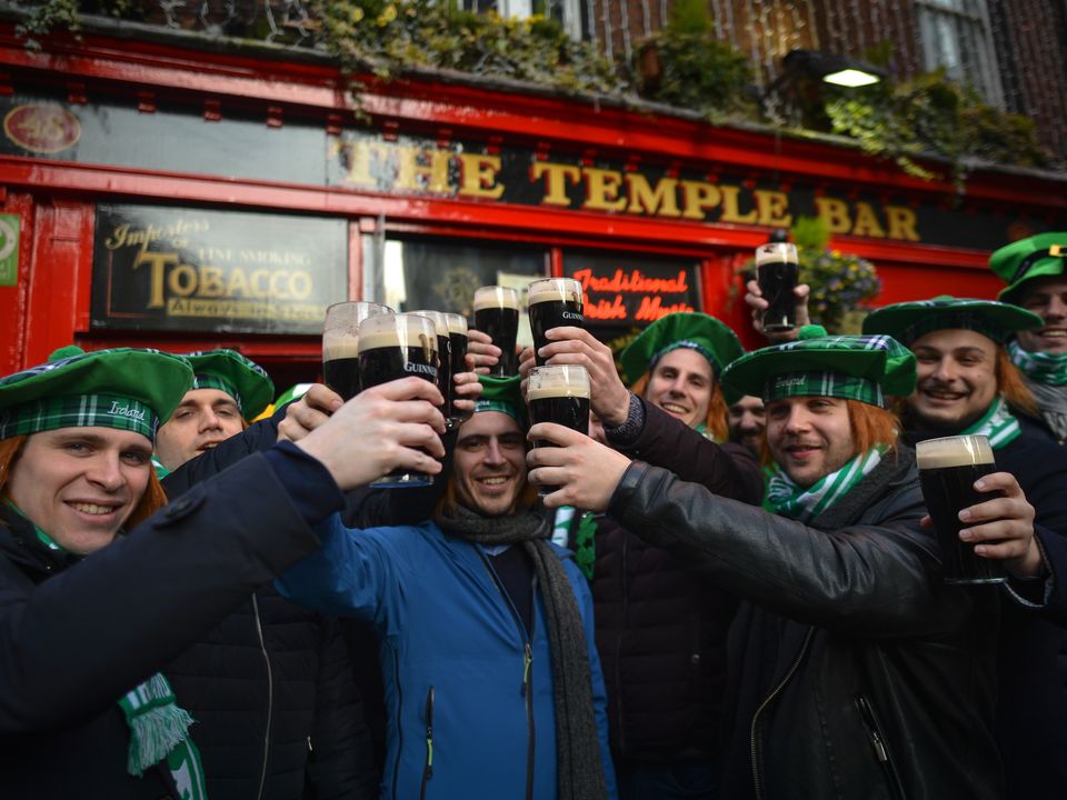 People enjoy a pint in Dublin over the St Patrick’s weekend in 2019. Photo by Artur Widak via Getty Images