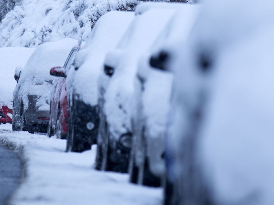 Cars covered with snow amid cold weather (David Cheskin/PA)