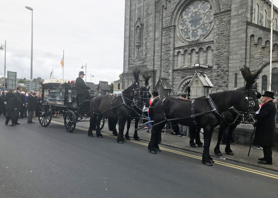 The horse drawn hearse bearing the remains of businessman Patrick (Pa) Keane arrives at St. Mary's Church
