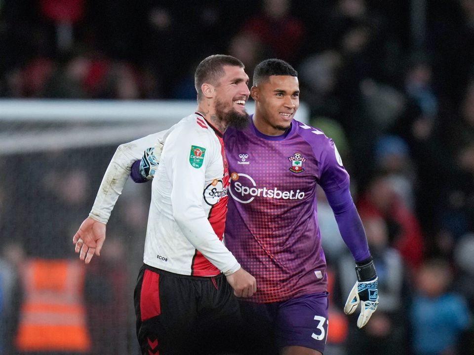 Southampton's Lyanco, left, and goalkeeper Gavin Bazunu celebrate at the end of the English League Cup quarter final soccer match between Southampton and Manchester City at St Mary's stadium in Southampton, England, Wednesday, Jan. 11, 2023. Southampton won 2-0. (AP Photo/Alastair Grant)