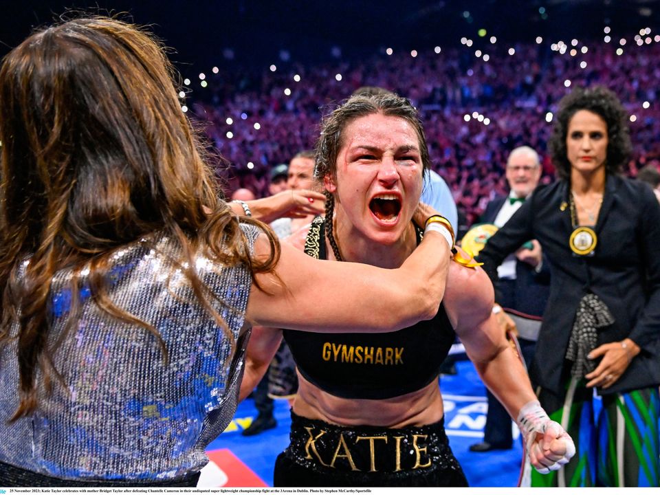 25 November 2023; Katie Taylor celebrates with mother Bridget Taylor after defeating Chantelle Cameron in their undisputed super lightweight championship fight at the 3Arena in Dublin. Photo by Stephen McCarthy/Sportsfile